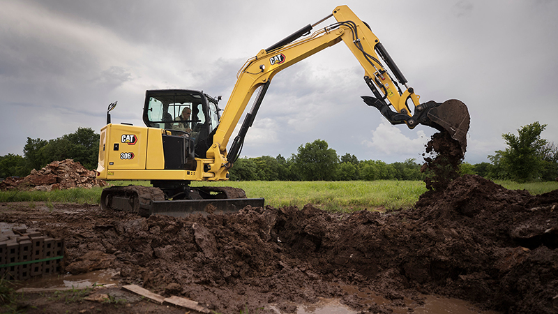 Small excavator digging hole
